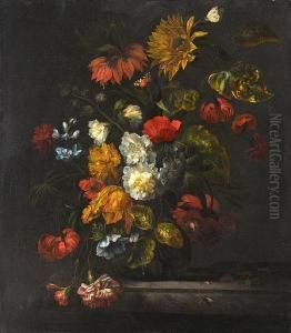 A Sunflower, Carnations, Roses, Tulips Andother Flowers In A Glass Vase On A Marble Ledge