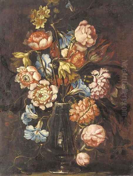 Carnations, tulips, daffodils, roses and other flowers in a glass vase on a ledge - view 1