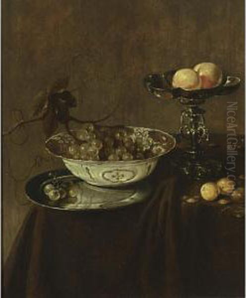 A Still Life With A Wan-li Porcelain Bowl With Grapes On A Pewter Plate, A Silver Tazza With Peaches, Together With Plums And Nuts, All On A Draped Table - view 1