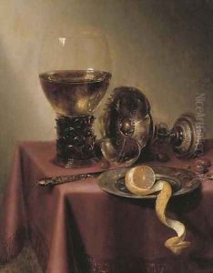 An upturned silver tazza, hazelnuts, a peeled lemon on a pewter platter, a knife and a roemer, on a draped table by Maerten Boelema De Stomme