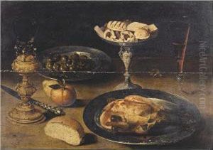 Still Life With A Roast Chicken 
On A Pewter Plate, Sweetmeats On A Tazza, A Roemer On A Gilt Stand, A 
Glass Of Wine, Olives In A Pewter Dish, A Knife, A Bread Roll And Fruit,
 All On A Table