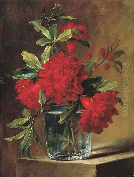 Pomegranate blossoms in a glass vase on a stone ledge - view 1