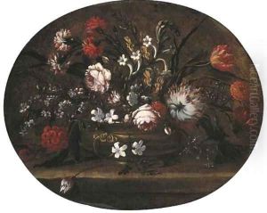 Roses, tulips, carnations and other flowers in a bronze vase on a ledge