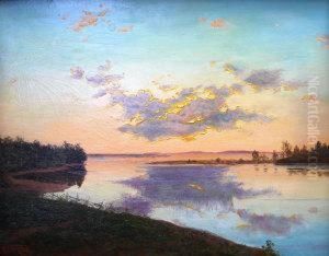 View Of A Lake With Woodland At Sunset