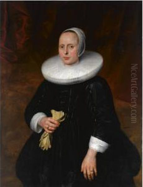 A Portrait Of A Lady, Standing
Three-quarter Length, Wearing A Black Dress With A Mill-stone Collar And
A White Bonnet, Holding Gloves - view 1