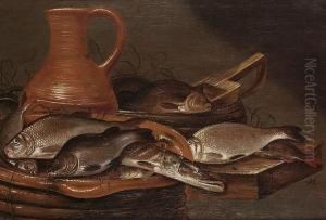 A Pike, Carp, And Other Fish On An Earthern Ware Plate With A Jug On A Table Top by Pieter de Putter