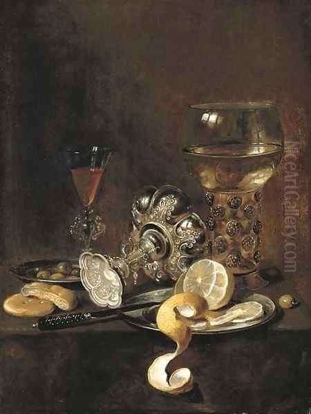 A giant roemer, an upturned goblet, a glass, bread, a knife and a partly-peeled lemon on a platter, on a table - view 1