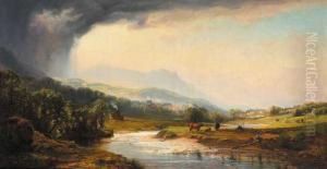 Landscape With A View Towards A Town And Grazing Cattle In Foreground
