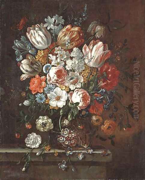 Roses, parrot tulips, an iris, narcissi and other flowers in a glass vase on a stone ledge - view 1