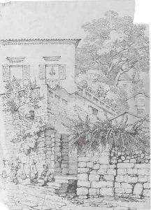 Women seated outside the gate of a house
