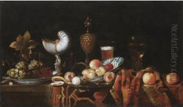 Still Life With Pears, Apples,
Grapes In A Ceramic Bowl, A Partly Peeled Lemon, A Nautilus Cup, A
Roemer And A Beer Glass, All Arranged On A Table Partly Draped With A
Carpet - view 1