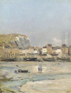 Sailboats Beached On The Shore Of A Seaside Town