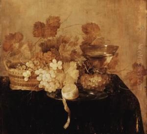 Grapes In A Wicker Basket, A 
Roemer And A Peeled Lemon On A Pewterplate On A Draped Table