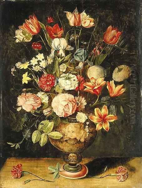 Tulips, irises, roses, carnations, lilies, narcissi and other flowers in a sculpted urn on a table - view 1