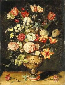 Tulips, irises, roses, carnations, lilies, narcissi and other flowers in a sculpted urn on a table