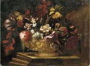 Flowers In A Decorative Gold Vase On A Stone Plinth