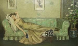 Interior Scene With Woman Reclined On Couch Holding Book And
 Wearing Gold/green Evening Dress On The Green Floral Couch Before A
 Silver Tea Set, With Japanese Prints Hung On Wall In Background And
 A Screen Behind Potted Flowers To Right by Joseph Alfred Terry