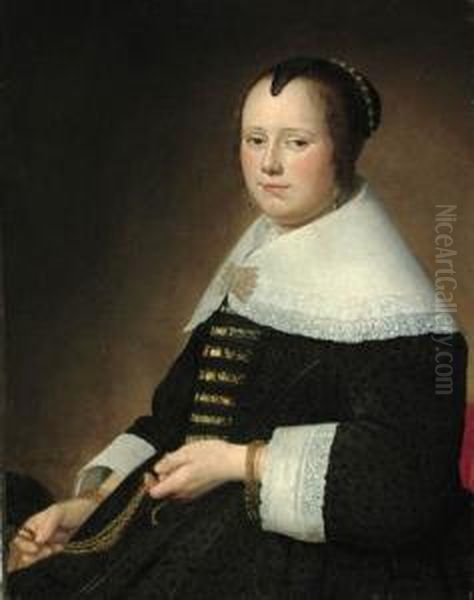 Potrait Of A Lady,
Three-quarter-length, In A Black Dress With Gold Brocade, And A White
Collar, Holding A Gold Chatelaine - view 1