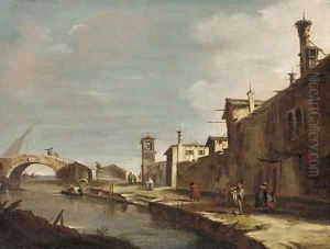 A Venetian canal with figures on a path by Francesco Guardi