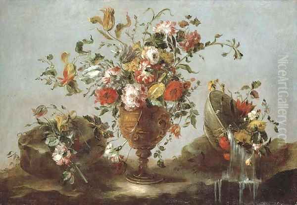 Roses, peonies and tulips in a gold sculpted urn with flowers in a pewter bowl by a rock pool - view 1