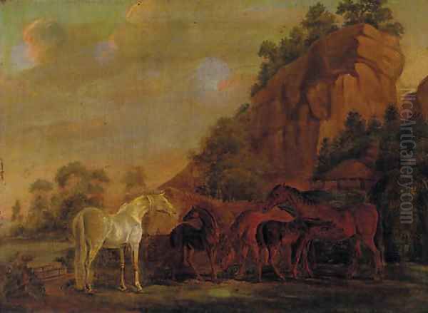 Mares and foals by a rocky outcrop - view 1