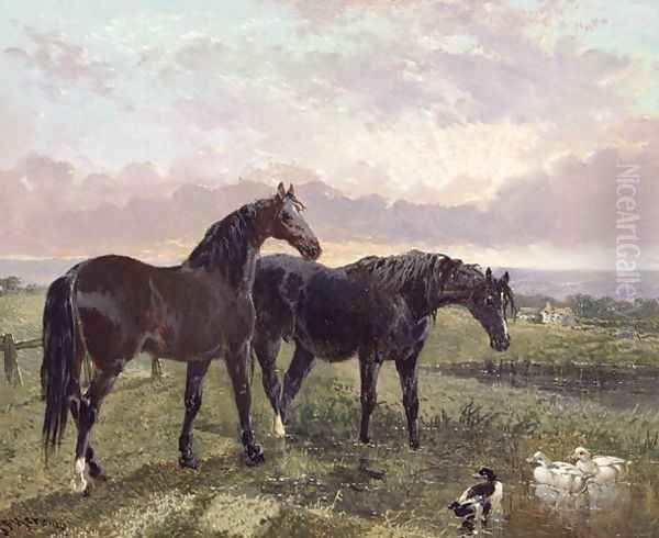 Two horses grazing at sunset - view 1