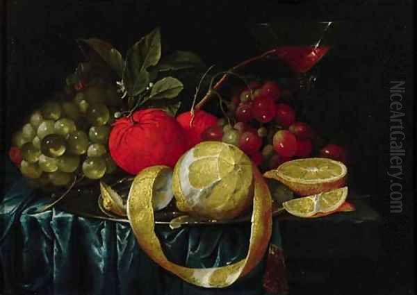 A peeled lemon, oranges, grapes on a pewter plate, and a Facon-de-Venice wineglass on a draped table - view 1