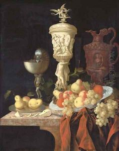 A nautilus cup, a sculpted marble urn, a sculpted porphyry jug and other vessels with oranges, apples, pears and grapes in a blue and white porcelain by Johann Georg (also Hintz, Hainz, Heintz) Hinz