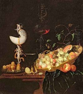 A Still Life of fruit with a nautilus cup on a draped ledge by Georg Hinz