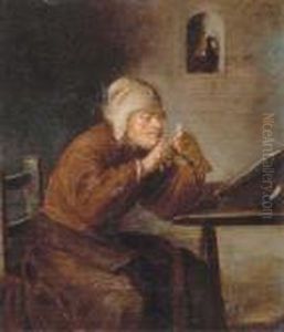 A Man Seated At His Desk Sharpening His Pen