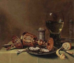 A roemer, an overturned goblet, oysters on a pewter plate