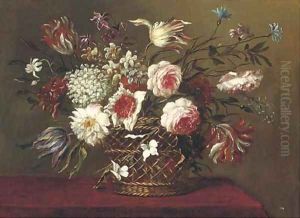 Parrot tulips, narcissi, roses and other flowers in a basket on a table