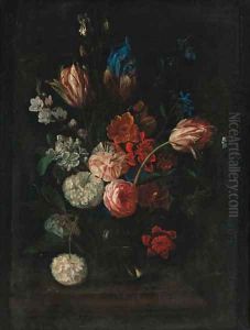 Carnations, tulips, peonies, irises and other flowers in a glass bowl on a ledge