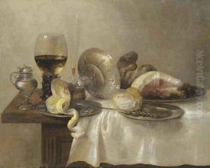 An upturned silver tazza and a partially peeled lemon on a pewter platter