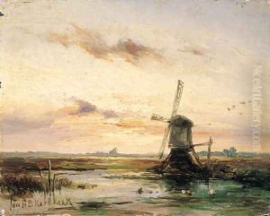 A windmill in a polder landscape at sunset