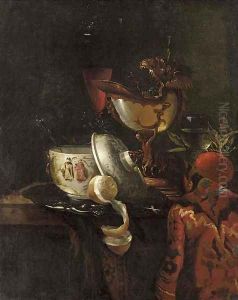 A nautilus cup, an oriental bowl on a silver tray and glasses of wine on a table by Willem Kalf