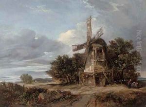 A wooded landscape with a windmill and a figure on a track