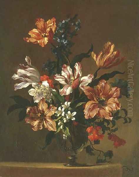 Parrot tulips and other flowers in a glass vase on a stone ledge - view 1