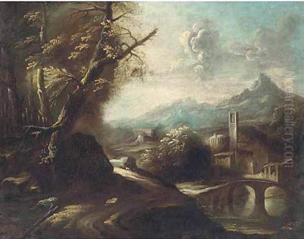 A wooded track by a river with a town beyond - view 1