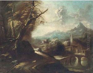 A wooded track by a river with a town beyond