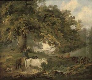 A countryman and horses in a wood, figures around a camp fire in the distance by George Morland