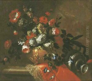 Flowers in a sculpted vase on a draped ledge