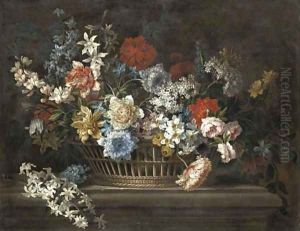 Peonies, narcissi, daffodils and other flowers in a basket on a stone ledge