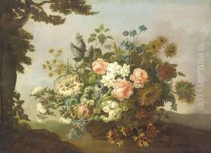 Roses, carnations, sunflowers, honeysuckle and other flowers in a basket by a tree in a hilly landscape