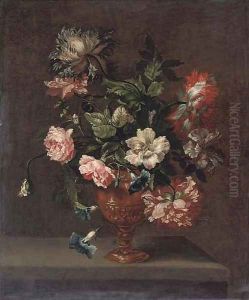 Roses, peonies and convulvulus in a sculpted urn on a stone ledge