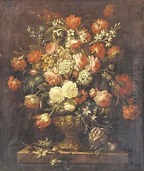 Roses, tulips, carnations, forget-me-nots and other flowers in a sculpted urn on a ledge - view 1