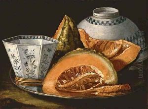 Melon and an octagonal cup on a silver charger, an upturned bowl behind
