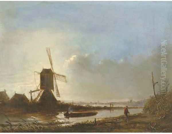 A windmill in a polder landscape at sunset - view 1