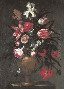 Irises, tulips, roses and other flowers in a sculpted vase