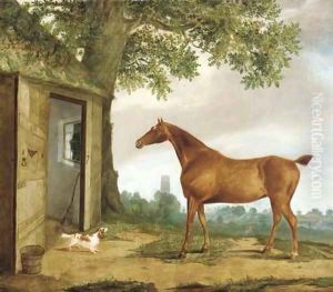 A chestnut hunter and spaniel before a stable, a church beyond